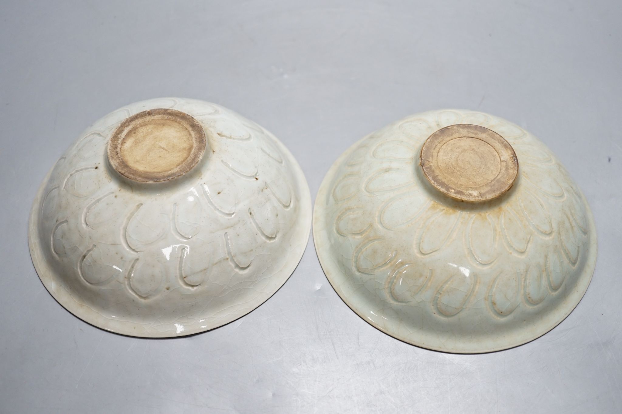 Two Chinese carved celadon dishes, 18cm. diam., and a celadon vase